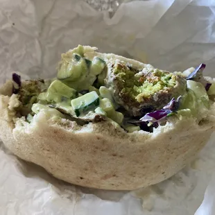 Falafel pita with cucumber, eggplant and cabbage, hummus and tahini. Yummmm