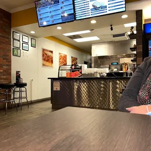 a woman sitting at a table in a restaurant