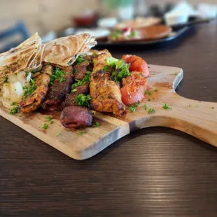 a plate of food on a wooden cutting board