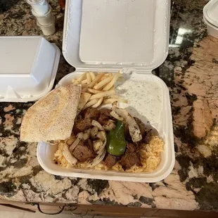 Lamb kebabs with french fries and rice