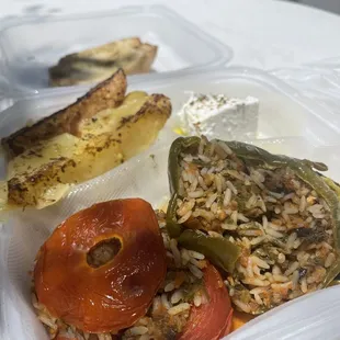Gemista-- comes with two peppers stuffed with rice, 2-3 roasted delicious potatoes, small feta cheese in olive oil, and garlic bread.