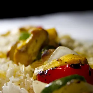 Chicken Kabob is marinated in house with our family recipe and grilled, with veggies and rice