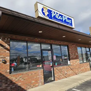Outside - nice clean, bright sign and nice brick storefront