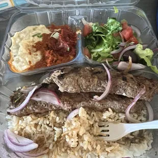 Beef and lamb kofta with salad and baba ganouj, fire, and red pepper spreads.