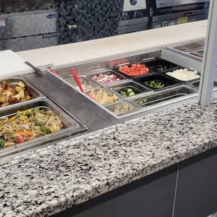 a variety of food in a buffet