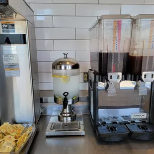 a beverage dispenser and other items on a counter