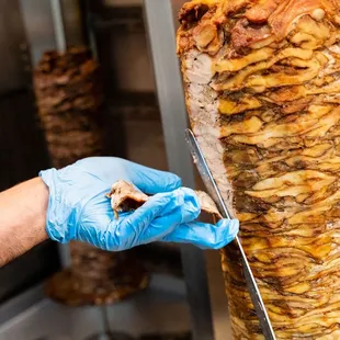 a person in blue gloves holding a knife