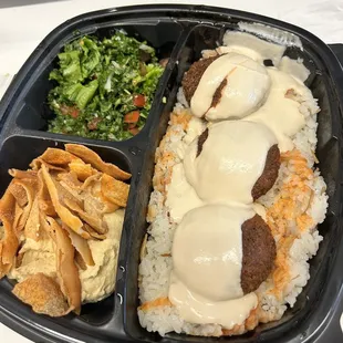 Falafel Plate with rice, hummus, and tabouleh plus hot sauce and tahini
