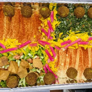 a platter of pita and vegetables