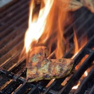 a pita on a grill with flames