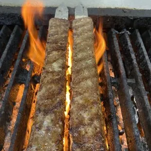 two hot dogs on a grill