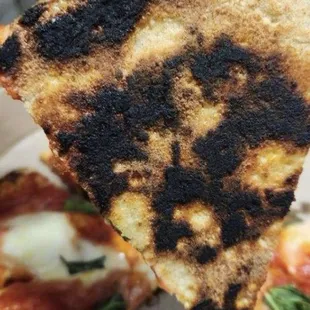 The pizza from Pitalian was burnt and tasted burnt.