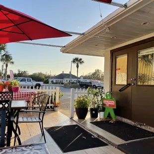 a patio with chairs and umbrellas