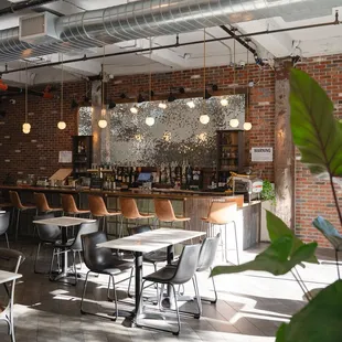 the interior of a restaurant with tables and chairs