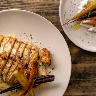 a plate of chicken, carrots, and mashed potatoes