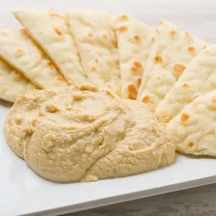 Creamy hummus served with delicious and warm pita bread.