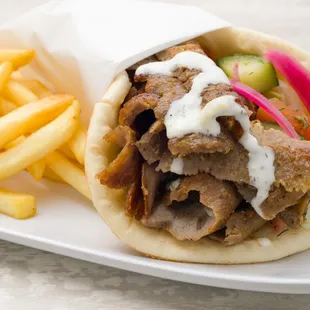 Fresh carved gyro meat with tzatziki sauce and side of fires. You can&apos;t beat that!