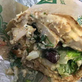 Mid East Piece wrap- chicken, tabouli, hummus, feta, lettuce, olives, tahini on whole wheat wrap $7 (photo shows half)