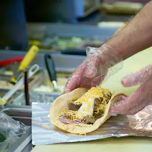 a person preparing a pita