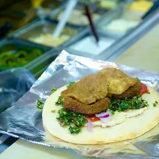 a pita sandwich with meat and vegetables