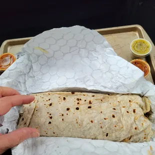 a person holding a burrito