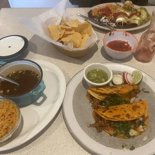 lower rt - Taco de Birria lower lf - dipping sauce and rice middle - complimentary chips &amp; salsa top lf - Enchiladas Suizas
