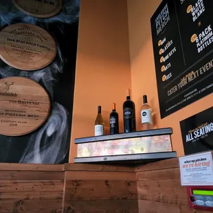 a bar with a menu and bottles of alcohol