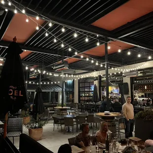 a group of people sitting at tables in a restaurant