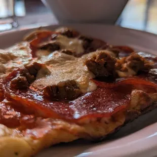 a slice of pizza on a plate