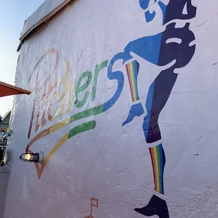 a baseball player painted on the side of a building