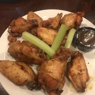 a plate of chicken wings and celery