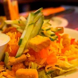 a plate of salad with dressing