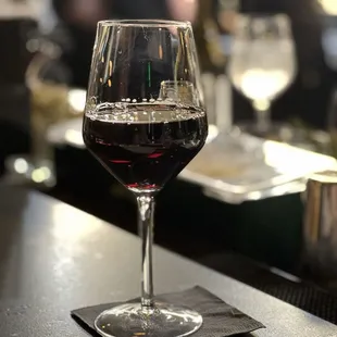 a glass of wine on a bar