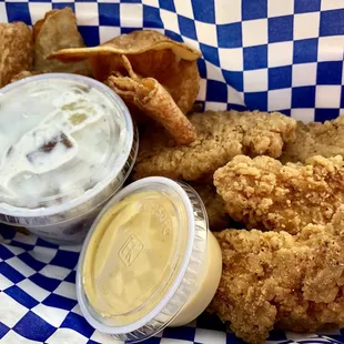 Blue and gold chicken tenders with homemade chips, potato salad and honey mustard