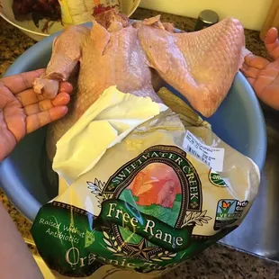 a person holding a bag of chicken