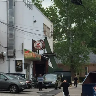 Down the alley on the left. Can't miss it.