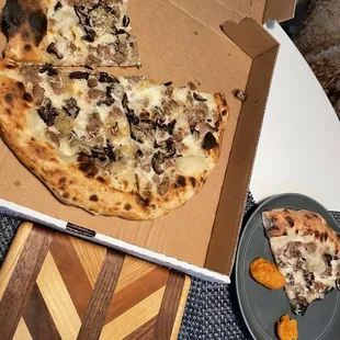 a half eaten pizza in a box