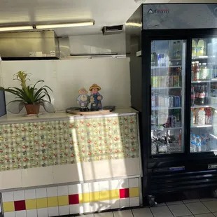 Drink cooler and cooking area. They also have fountain drinks.