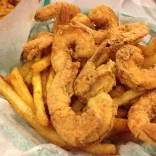 a basket of fried shrimp and fries