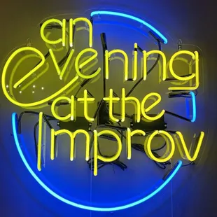 an evening at the improv neon sign