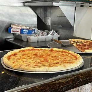 Pizzas ready to be sold by the slice.