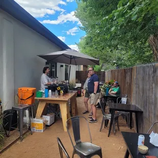 a group of people standing around a table