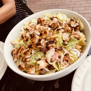 a bowl of salad with chicken and lettuce