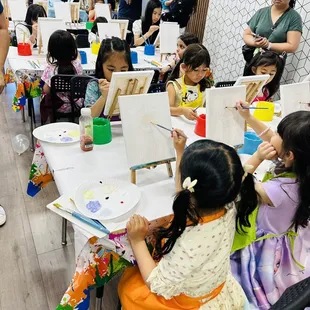 Guests enjoying paint time led by art instructor Mai.