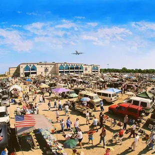a crowd of people at a car show