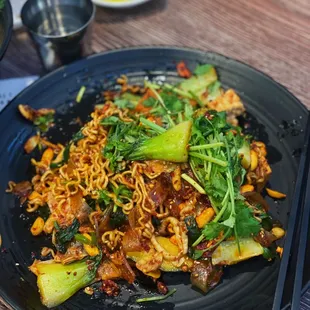 a plate of noodles and vegetables