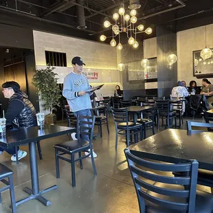 people sitting at tables in a restaurant