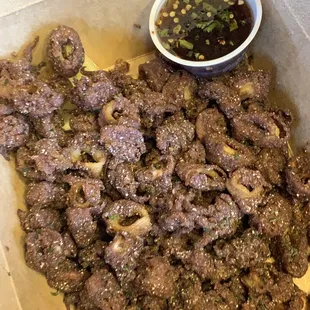 a box of meat and a bowl of sauce