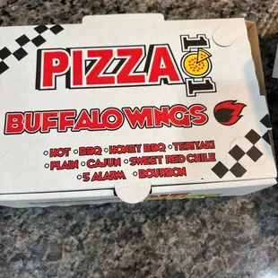 a box of pizza sitting on a counter