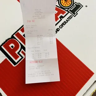 a receipt on a pizza box